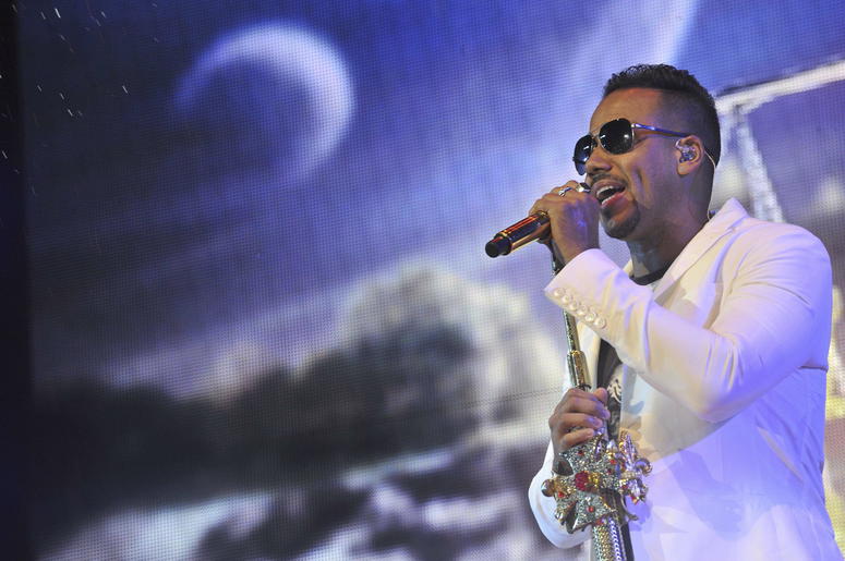 Romeo Santos singing into a microphone