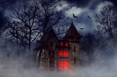 Creepy house with bats and red light from the windows