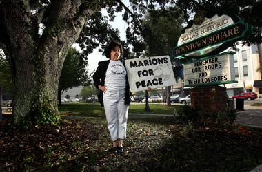 Delphine Herbert, 71, stands in the town square in Ocala, Florida, where she holds protest on the weekend. The sign, "MARIONS FOR PEACE," references Marion County residents. (Photo by Charles Trainor Jr./Miami Herald/MCT/Sipa USA)