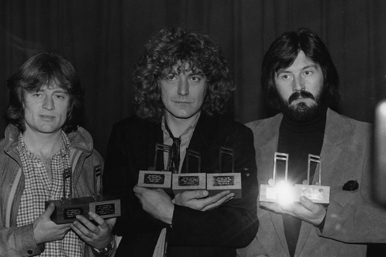 Led Zeppelin with their seven Melody Maker awards. They are, from left to right John Paul Jones (bass, keyboards), Robert Plant (vocals) and John Bonham (1947 - 1980) (drums) Led Zeppelin with their seven Melody Maker awards. They are, from left to right John Paul Jones (bass, keyboards), Robert Plant (vocals) and John Bonham (1947 - 1980) (drums)