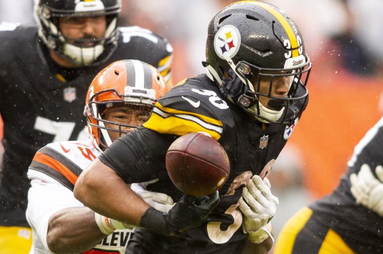 Cleveland Browns defensive end Myles Garrett (95) forces a fumble by Pittsburgh Steelers running back James Conner (30) during the fourth quarter at FirstEnergy Stadium. Cleveland Browns defensive end Myles Garrett (95) forces a fumble by Pittsburgh Steelers running back James Conner (30) during the fourth quarter at FirstEnergy Stadium.