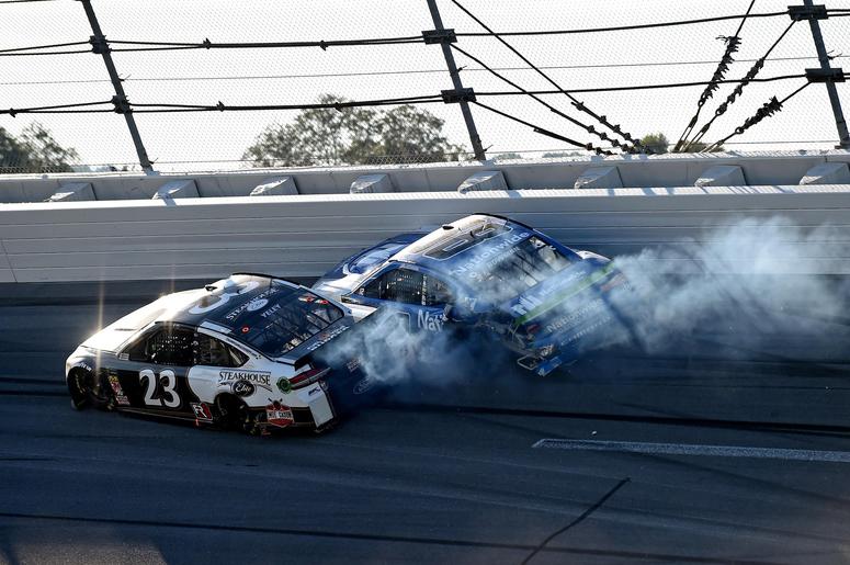 NASCAR Cup Series driver Alex Bowman (88) and NASCAR Cup Series driver JJ Yeley (23) wrecks during the 1000Bulbs.com at Talladega Superspeedway. NASCAR Cup Series driver Alex Bowman (88) and NASCAR Cup Series driver JJ Yeley (23) wrecks during the 1000Bulbs.com at Talladega Superspeedway.