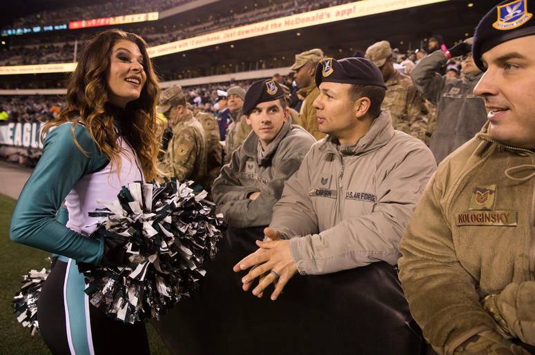 A Philadelphia Eagles cheerleader talks with members of the military during the fourth quarter against the Dallas Cowboys at Lincoln Financial Field. A Philadelphia Eagles cheerleader talks with members of the military during the fourth quarter against the Dallas Cowboys at Lincoln Financial Field.