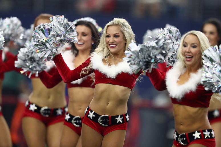 allas Cowboys cheerleaders perform in holiday outfits during the halftime show for the game against the Tampa Bay Buccaneers at AT&T Stadium. allas Cowboys cheerleaders perform in holiday outfits during the halftime show for the game against the Tampa Bay Buccaneers at AT&T Stadium.