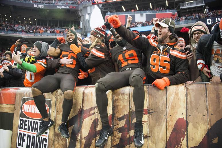 Cleveland Browns linebacker Xavier Woodson-Luster (56) and wide receiver Breshad Perriman (19) celebrate with fans after the Browns beat the Cincinnati Bengals at FirstEnergy Stadium. Cleveland Browns linebacker Xavier Woodson-Luster (56) and wide receiver Breshad Perriman (19) celebrate with fans after the Browns beat the Cincinnati Bengals at FirstEnergy Stadium.