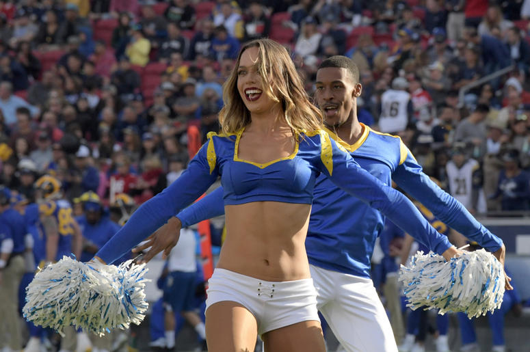 os Angeles Rams cheerleader Sydney Zmrzel (left) and Quinton Peron perform during the game against the San Francisco 49ers at Los Angeles Memorial Coliseum. os Angeles Rams cheerleader Sydney Zmrzel (left) and Quinton Peron perform during the game against the San Francisco 49ers at Los Angeles Memorial Coliseum.