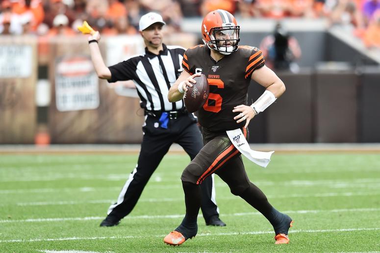 Cleveland Browns quarterback Baker Mayfield (6) scrambles as field judge Michael Banks (72) throws a penalty flag during the second half against the Tennessee Titans at FirstEnergy Stadium. Cleveland Browns quarterback Baker Mayfield (6) scrambles as field judge Michael Banks (72) throws a penalty flag during the second half against the Tennessee Titans at FirstEnergy Stadium.