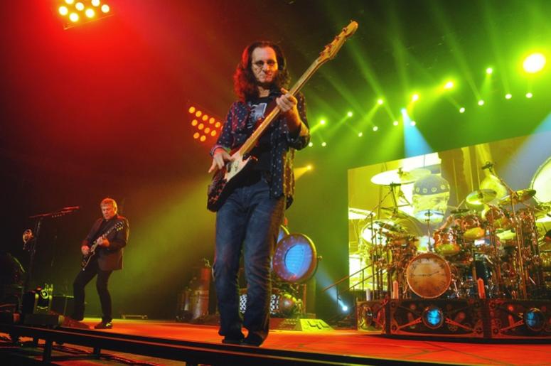 Geddy Lee (lead vocalist and bassist), Alex Lifeson (guitarist), and Neil Peart (drummer) of iconic Canadian rock band Rush Geddy Lee (lead vocalist and bassist), Alex Lifeson (guitarist), and Neil Peart (drummer) of iconic Canadian rock band Rush