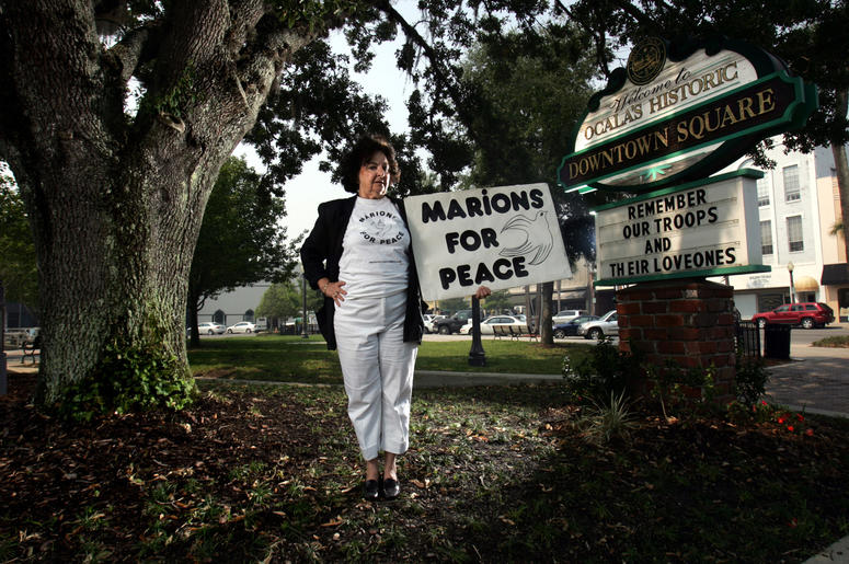 Delphine Herbert, 71, stands in the town square in Ocala, Florida, where she holds protest on the weekend. The sign, "MARIONS FOR PEACE," references Marion County residents. (Photo by Charles Trainor Jr./Miami Herald/MCT/Sipa USA)