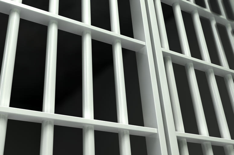 White bars of a jail cell. White bars of a jail cell.