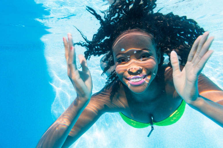 girl diving in swimming pool girl diving in swimming pool