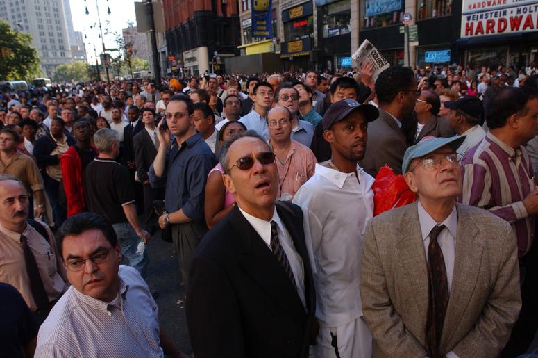 People watch World Trade Center burn September 11, 2001 after two hijacked airplanes slammed into the twin towers in New York City. People watch World Trade Center burn September 11, 2001 after two hijacked airplanes slammed into the twin towers in New York City. (Photo by Spencer Platt/Getty Images)