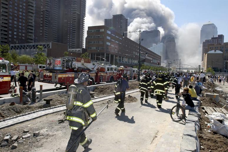 Fireman heading south on the West Side Highway towards the remains of the World Trade Center where smoke continued hours after the colapse. Streets of lower Manhattan with fireman, police, and rescue crews after the colapse of the World Trade Center after Fireman heading south on the West Side Highway towards the remains of the World Trade Center where smoke continued hours after the colapse. Streets of lower Manhattan with fireman, police, and rescue crews after the colapse of the World Trade Center after