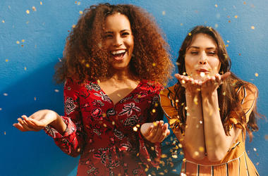 Two Women Blowing Glitter two women blowing glitter
