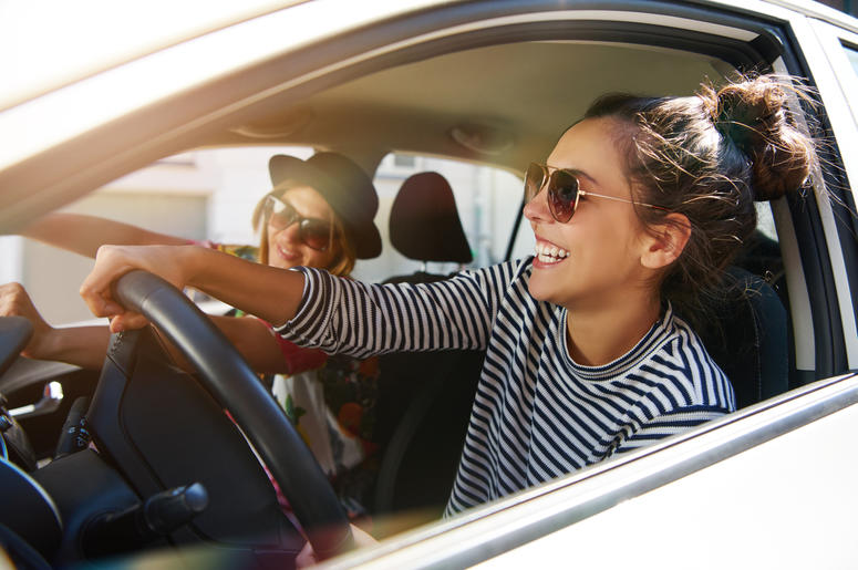 Two Girls Laughing Driving Car two girls driving laughing