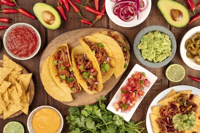 A plate of tacos and condiments