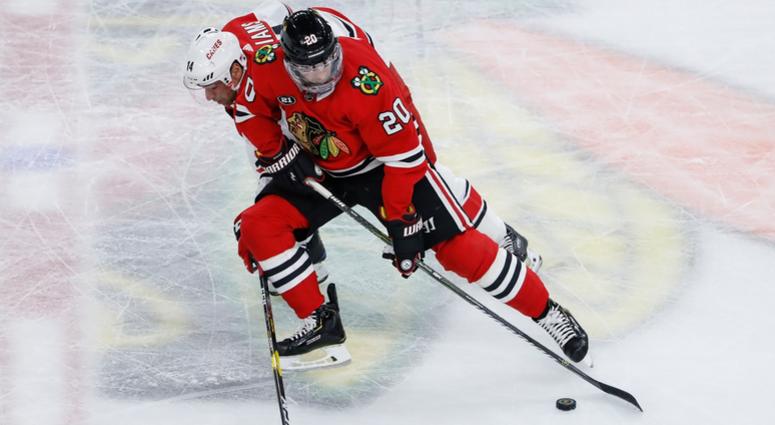 Blackhawks winger Brandon Saad (20) battles for the puck against Hurricanes winger Justin Williams (14). Blackhawks winger Brandon Saad (20) battles for the puck against Hurricanes winger Justin Williams (14).