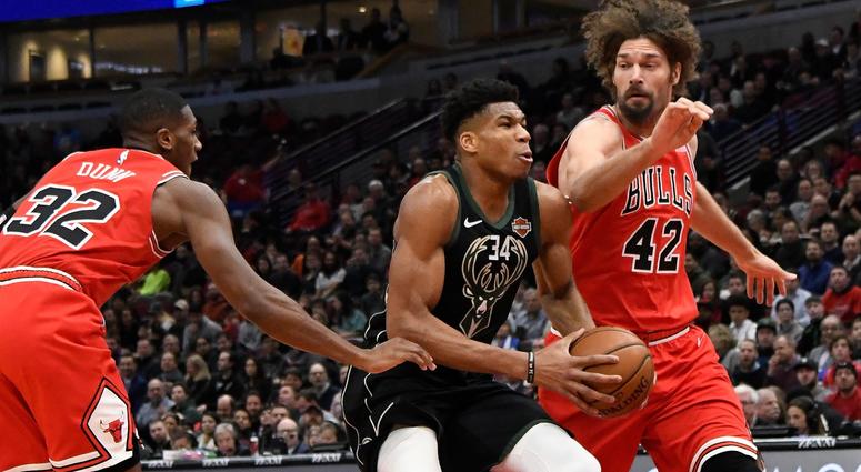 Bucks forward Giannis Antetokounmpo (34) drives the ball while defended by Bulls center Robin Lopez (42) and guard Kris Dunn (32). Bucks forward Giannis Antetokounmpo (34) drives the ball while defended by Bulls center Robin Lopez (42) and guard Kris Dunn (32).