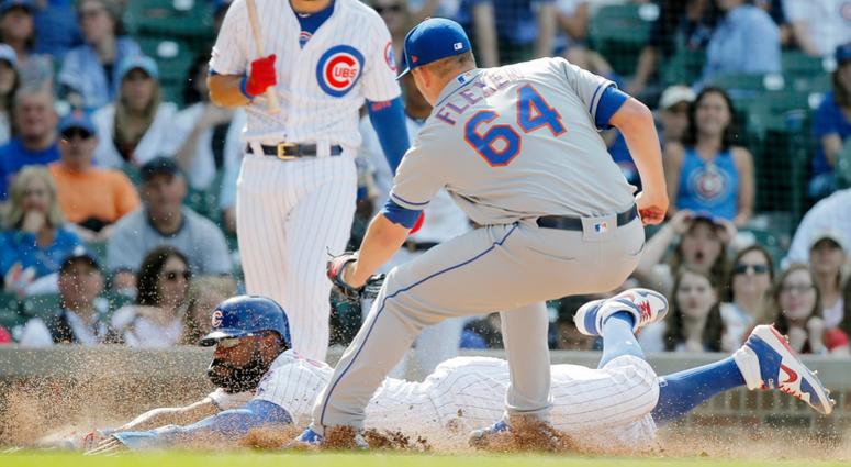 Cubs right fielder Jason Heyward (22) steals home after a wild pitch. Cubs right fielder Jason Heyward (22) steals home after a wild pitch.