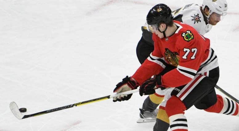 Blackhawks center Kirby Dach (77) tries to get past Golden Knights defenseman Jon Merrill (15). Blackhawks center Kirby Dach (77) tries to get past Golden Knights defenseman Jon Merrill (15).