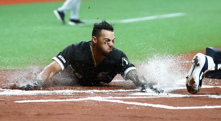 White Sox outfielder Leury Garcia (28) slides safe into home plate. White Sox outfielder Leury Garcia (28) slides safe into home plate.