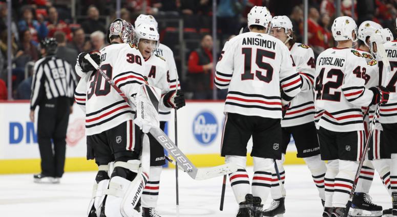 The Blackhawks celebrate after an overtime win against the Red Wings. The Blackhawks celebrate after an overtime win against the Red Wings.