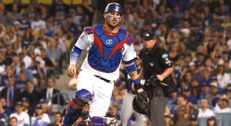 Dodgers catcher Yasmani Grandal chases a wild pitch. Dodgers catcher Yasmani Grandal chases a wild pitch.