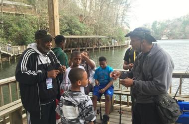 Officer Bruce Griggs (l) observes as the boys receive fishing lessons at YMCA Camp High HarboUr in Cartersville GA Officer Bruce Griggs (l) observes as the boys receive fishing lessons at YMCA Camp High HarboUr in Cartersville GA