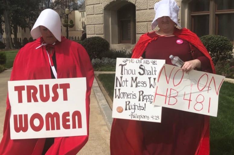 Dressed as characters from the fictional tv show and book "The Handmaids Tail" (about a totalitarian society) protestors have been assembling at the GA Capitol Dressed as characters from the fictional tv show and book "The Handmaids Tail" (about a totalitarian society) protestors have been assembling at the GA Capitol