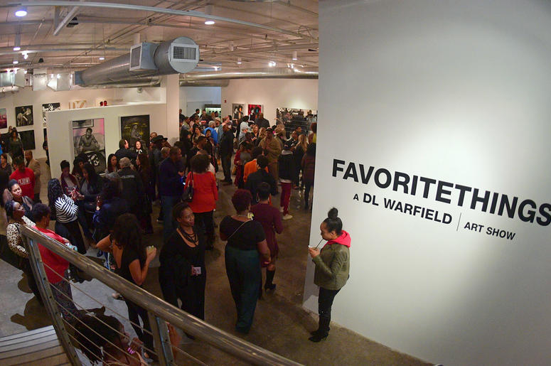 Attendees admire artwork created by D.L. Warfield, displayed during his "My Favorite Things" art exhibit on November 30, 2018, in Atlanta. Attendees admire artwork created by D.L. Warfield, displayed during his "My Favorite Things" art exhibit on November 30, 2018, in Atlanta.