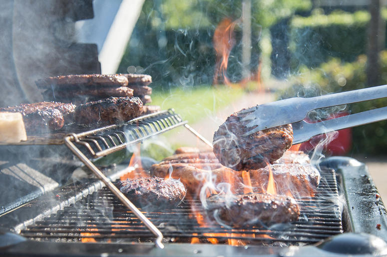 A grill with flame-broiling meats A grill with flame-broiling meats