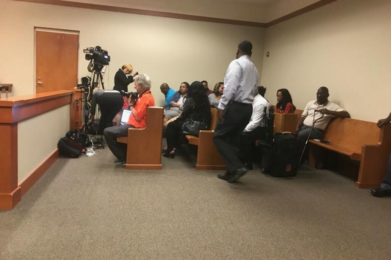 Community activists enter the courtroom where former DeKalb police officer Robert Olson's immunity hearing is being held