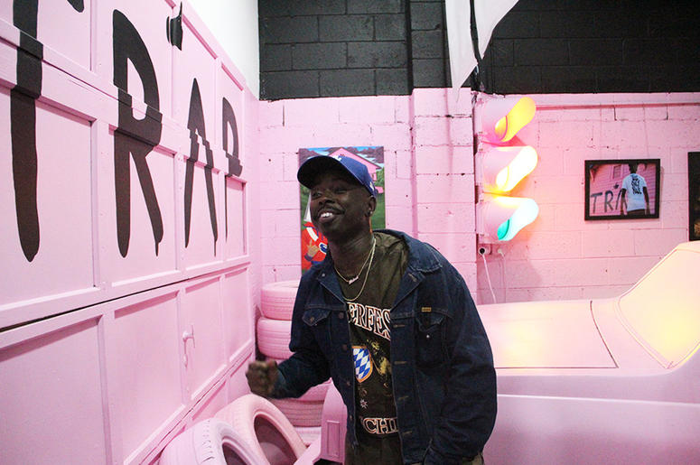 A man smiles while sitting on 2 Chainz's pink Chevy inside T.I.'s Trap Music Museum A man smiles while sitting on 2 Chainz's pink Chevy inside T.I.'s Trap Music Museum
