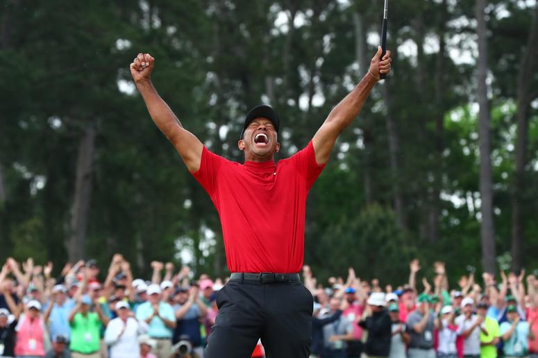 Tiger Woods celebrates after making a putt on the 18th green to win The Masters golf tournament at Augusta National Golf Club. Tiger Woods celebrates after making a putt on the 18th green to win The Masters golf tournament at Augusta National Golf Club.
