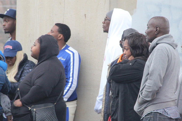 Rapper Young Thug (white hoodie) is among a group of onlookers at the scene of a deadly double shooting Rapper Young Thug (white hoodie) is among a group of onlookers at the scene of a deadly double shooting