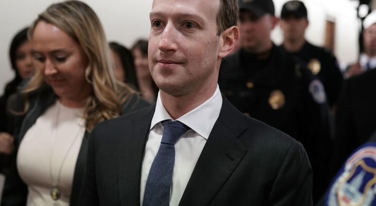 WASHINGTON, DC - APRIL 09: Facebook CEO Mark Zuckerberg (C) is escorted by U.S. Capitol Police as he walks in a hallway prior to a meeting with U.S. Sen. John Thune (R-SD), committee chairman of Senate Committee on Commerce, Science, and Transportation, A