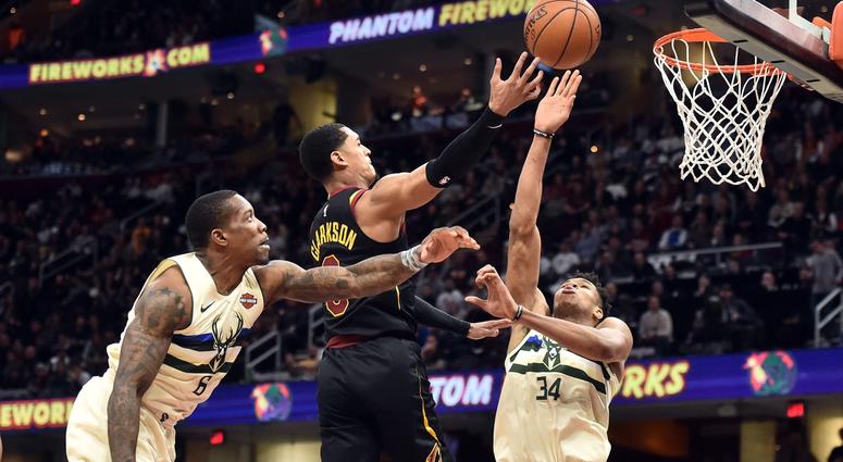 Mar 19, 2018; Cleveland, OH, USA; Cleveland Cavaliers guard Jordan Clarkson (8) drives to the basket between Milwaukee Bucks guard Eric Bledsoe (6) and forward Giannis Antetokounmpo (34) during the second half at Quicken Loans Arena.