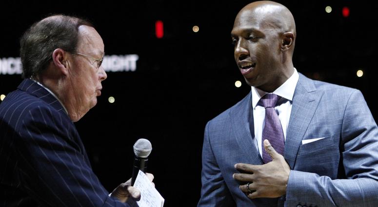 Feb 10, 2016; Auburn Hills, MI, USA; Chauncey Billups (right) shakes hands with television and radio play by play announcer George Blaha during the halftime retirement ceremony in the game between the Detroit Pistons and the Denver Nuggets at The Palace o