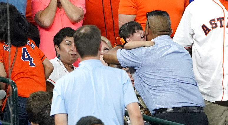 A young child is carried from the stands after being injured by a foul ball off the bat of Chicago Cubs' Albert Almora Jr.
