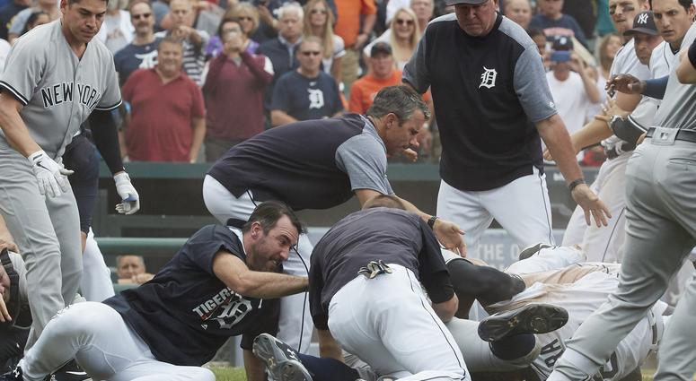 Aug 24, 2017; Detroit, MI, USA; Detroit Tigers manager Brad Ausmus (center) and starting pitcher Justin Verlander (left) try to get players off Detroit Tigers first baseman Miguel Cabrera (bottom right) after benches clear during the sixth inning.