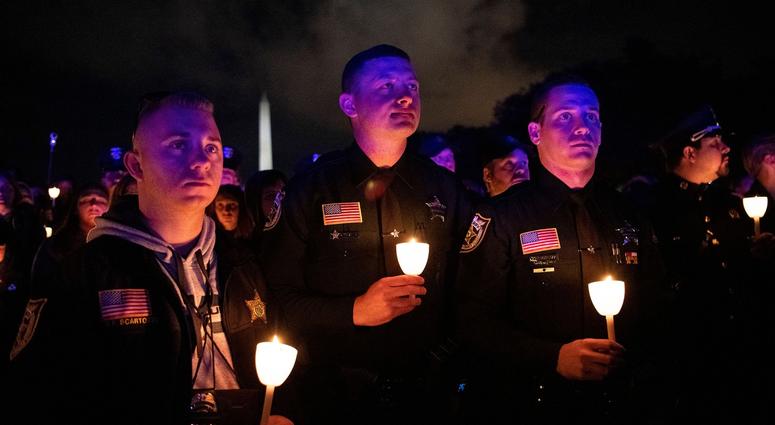 Vigils are being held all over the country to honor fallen officers. Pictured is a vigil held in Washington, DC
