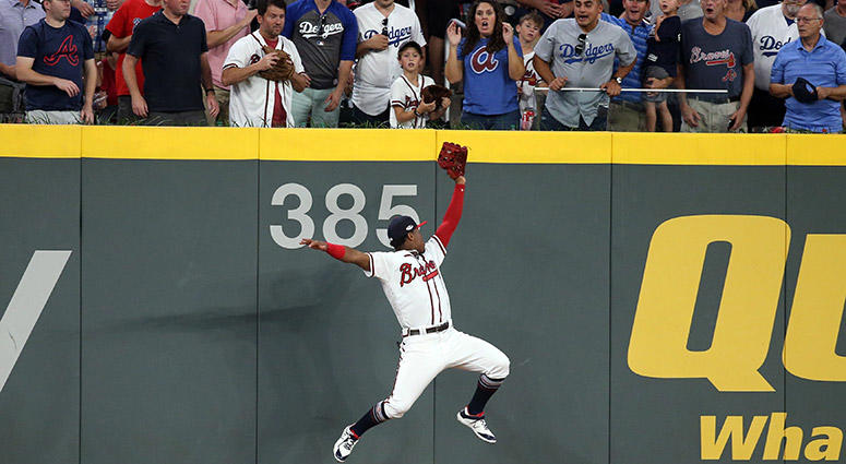 Atlanta Braves left fielder Ronald Acuna Jr. makes a catch at the wall Atlanta Braves left fielder Ronald Acuna Jr. makes a catch at the wall